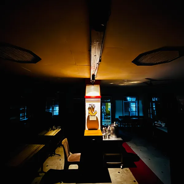 Dining hall at night with a spotlit Ganesha sculpture
