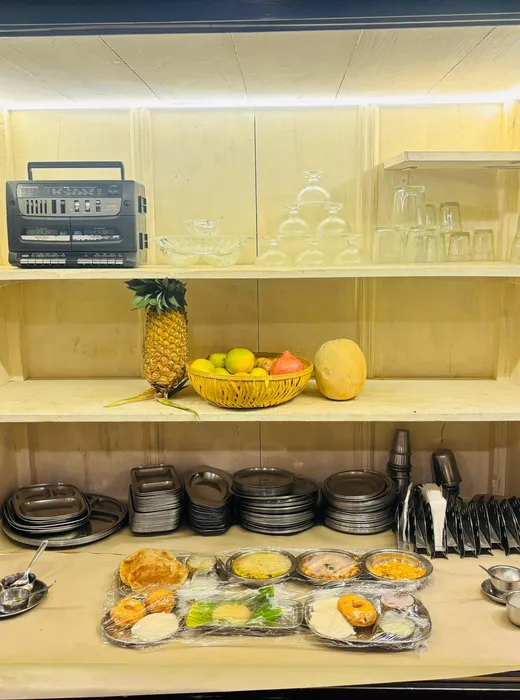The renovated wooden display cabinet with fresh fruit and a breakfast platter