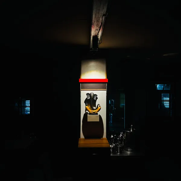 Stylised Ganesha sculpture under a spotlight